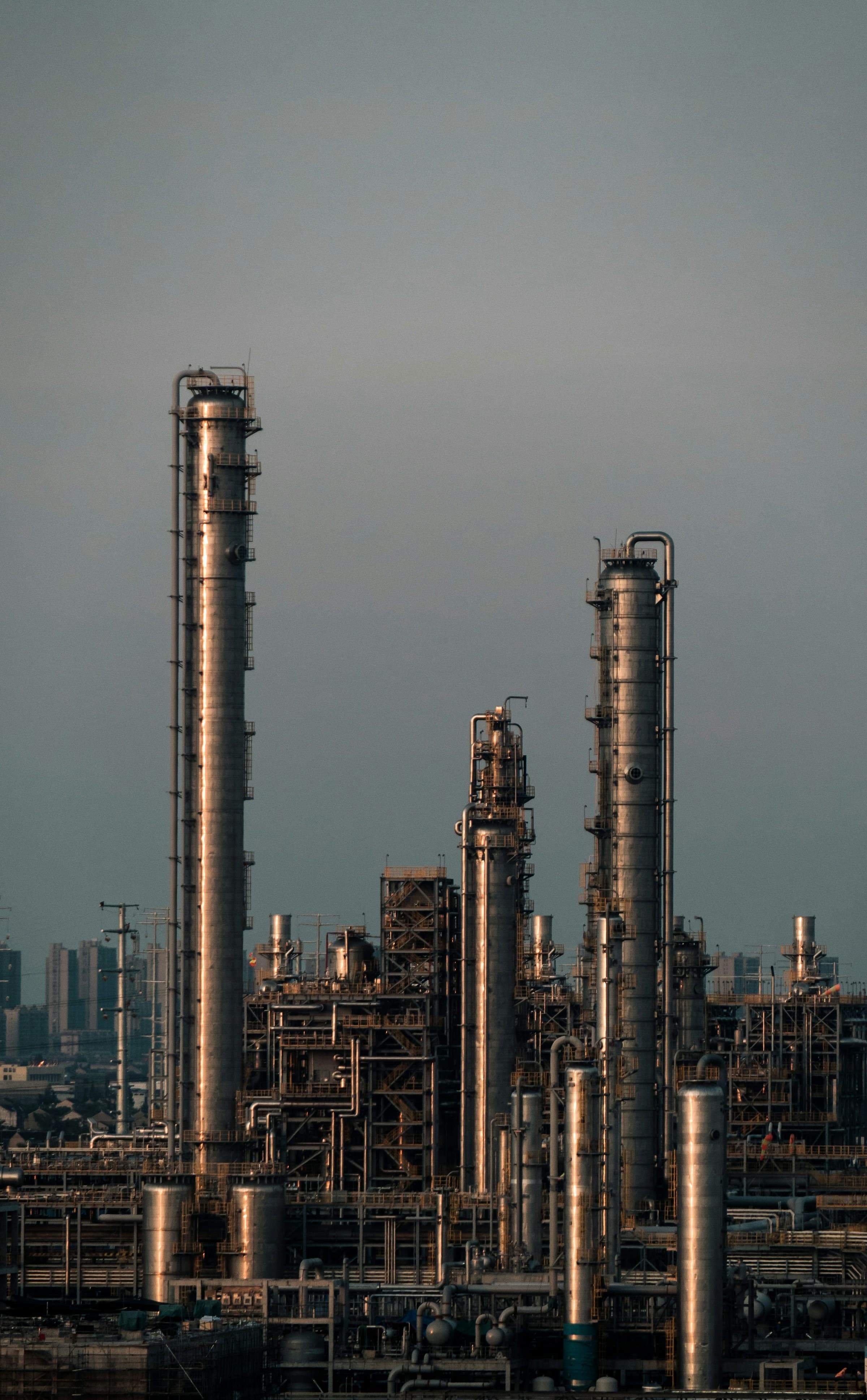 Steel towers, process piping, and platforms at an industrial facility